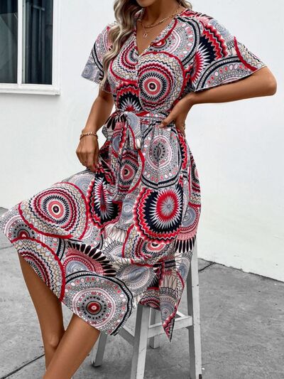 Load image into Gallery viewer, Slit Tied Printed Surplice Dress
