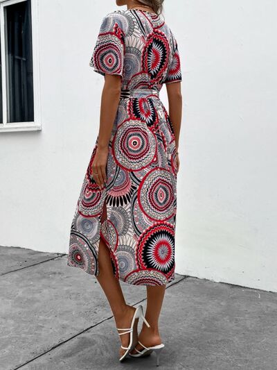 Load image into Gallery viewer, Slit Tied Printed Surplice Dress
