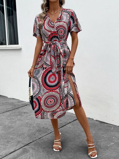 Load image into Gallery viewer, Slit Tied Printed Surplice Dress
